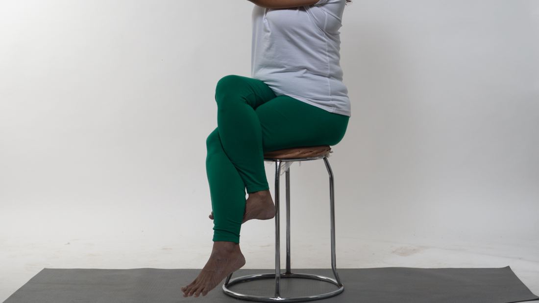 Tasneem practising seated on a chair