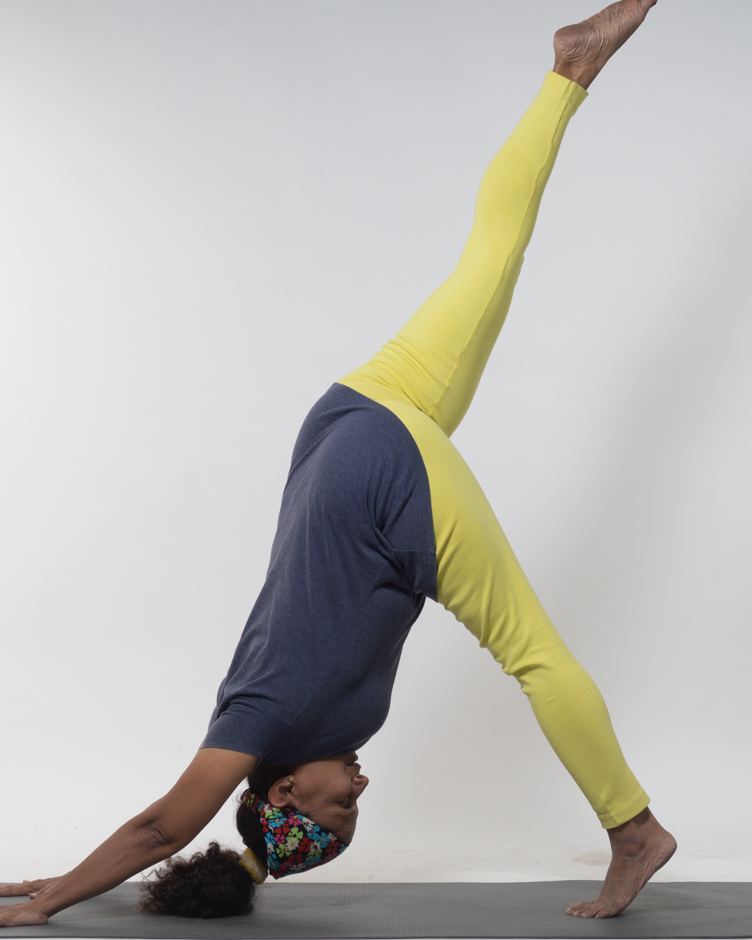 Tasneem in a three-legged downward dog