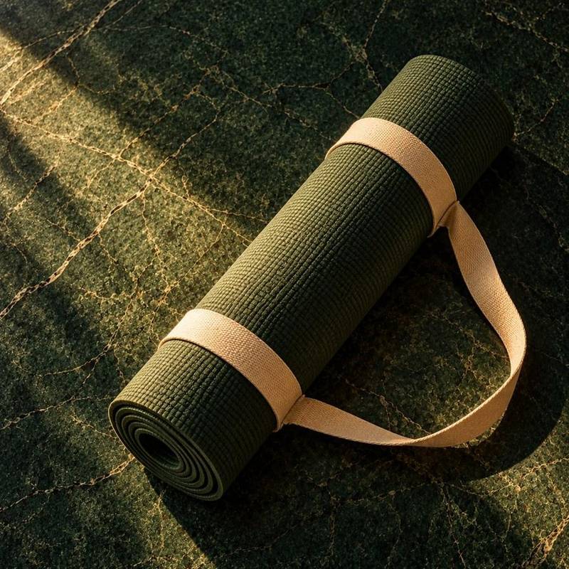 A rolled yoga mat in soft morning light